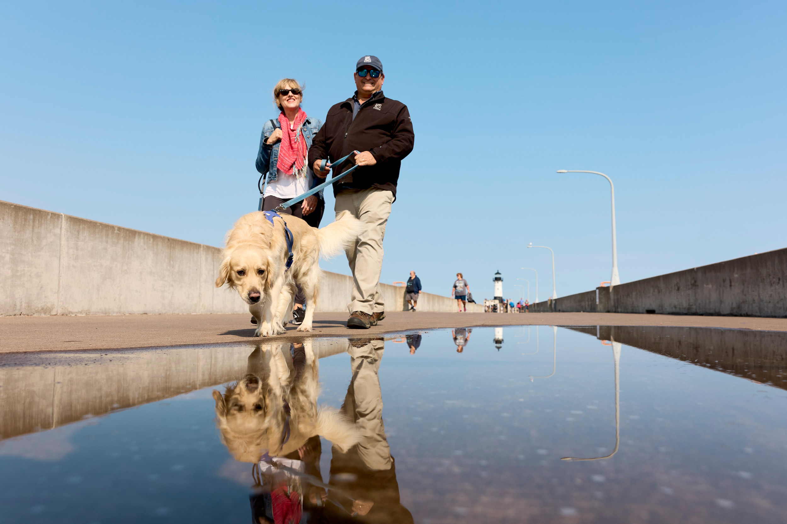 Jim Alman of Cirrus Aircraft walks with his wife in Canal Park