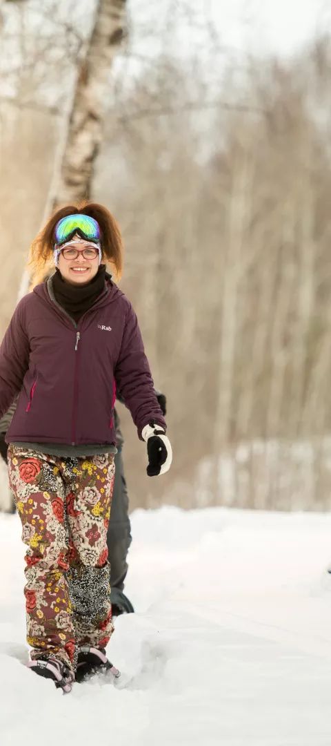 A woman snowshoeing in winter